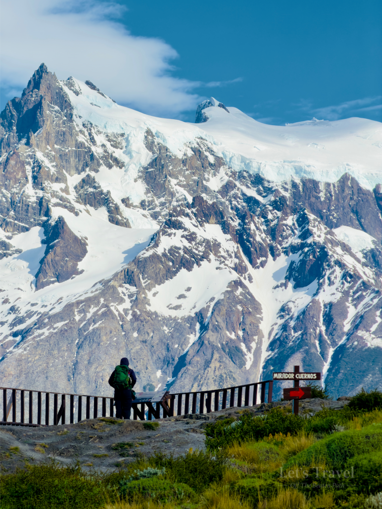 Hiker at Mirador Cuernos viewpoint in Torres del Paine National Park Chile with snow covered mountains