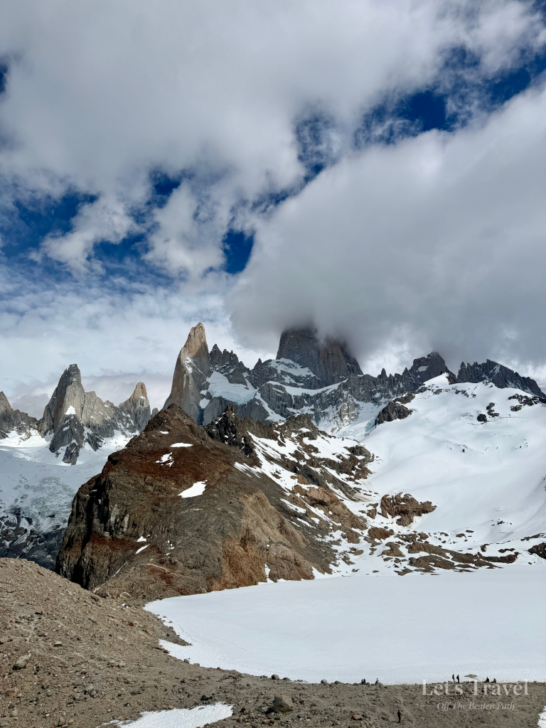 Mount Fitz Roy partially hidden by dramatic clouds above Laguna de los Tres in Los Glaciares National Park, Patagonia, Argentina.