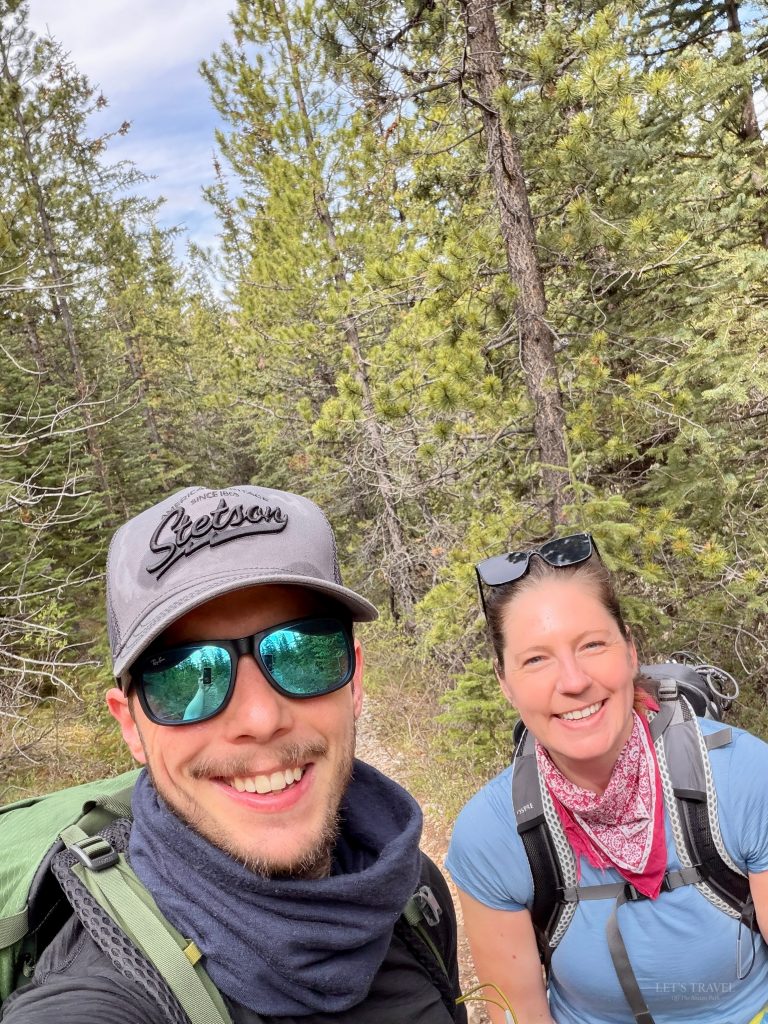 Smiling hikers taking a selfie on the forest section of the Sulphur Skyline Trail in Jasper National Park, Alberta, Canada.