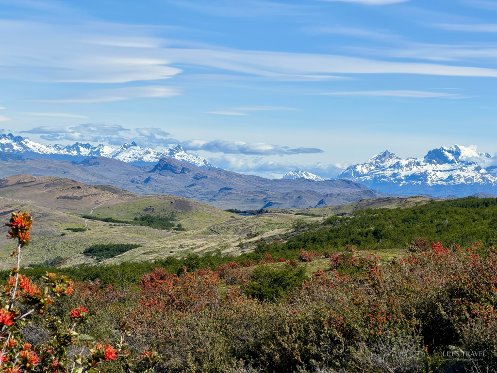 Panoramic view of snow-capped mountains and rolling hills in Torres del Paine National Park, Chilean Patagonia.