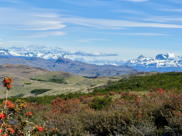 Panoramic view of snow-capped mountains and rolling hills in Torres del Paine National Park, Chilean Patagonia.